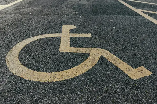 Accessibility symbol painted on a concrete floor