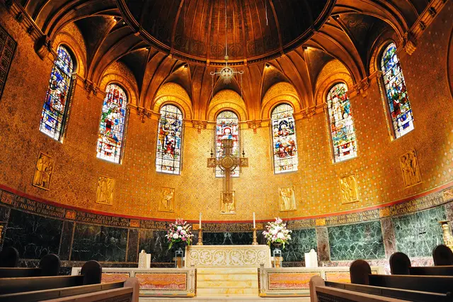 Inside the center of a church with painted windows