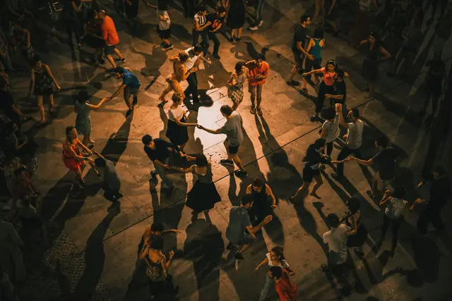 Groups of men and women dancing with each other