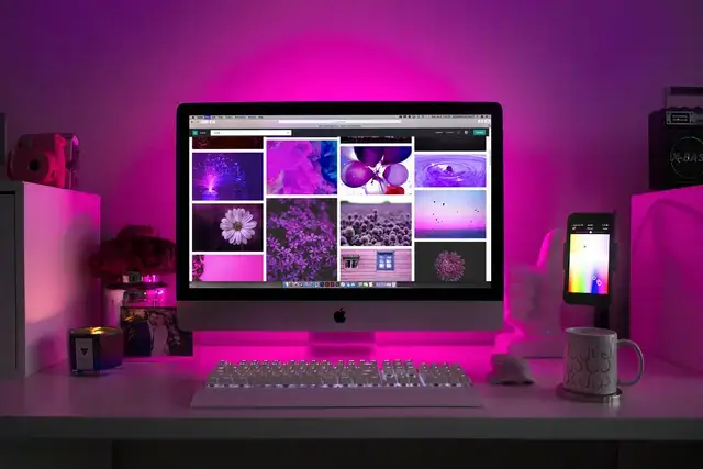 Mac computer glowing in a dark room